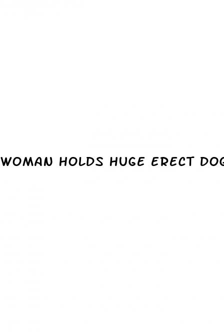 woman holds huge erect dog penis